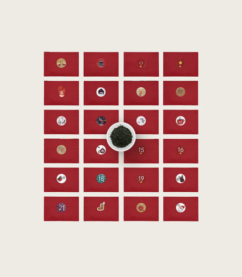 An advent-style gift set layout on a light warm gray background, showing a red grid of small square envelopes or cards with assorted illustrated icons, plus several red envelopes and a small printed card on the right.