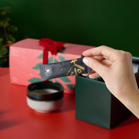 Hand taking a matcha sachet out of the advent calendar