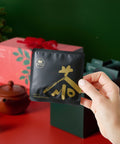 Hand taking a tea sachet out of the advent calendar
